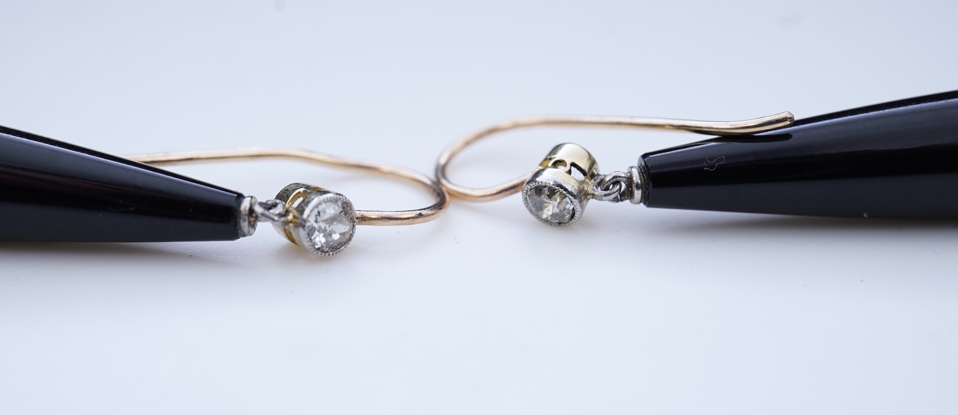 A pair of Art Deco onyx and diamond earrings, early 20th century